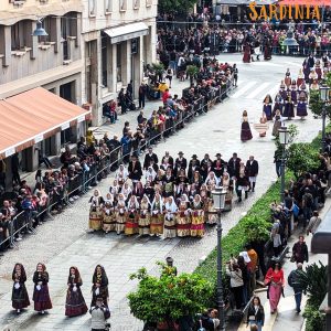 A group of people wearing traditional Sardinian costumes during the Festa di Sant'Efisio in Cagliari, showcasing intricate embroidery and vibrant colors.