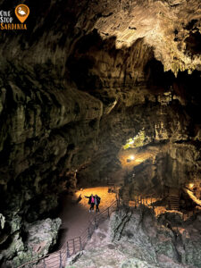 Inside Grotta di Su Marmuri: A stunning display of massive stalactites hanging from the ceiling and stalagmites rising from the floor, showcasing nature’s artistry over millions of years.